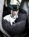 French bulldog sitting in black teddy dog car bed