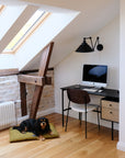black and brown dog laying on Chartreuse Green Le Noof Boucle Dog Pillow bed in home office