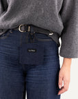 Woman wearing Le Noof's dark blue denim dog treat pouch