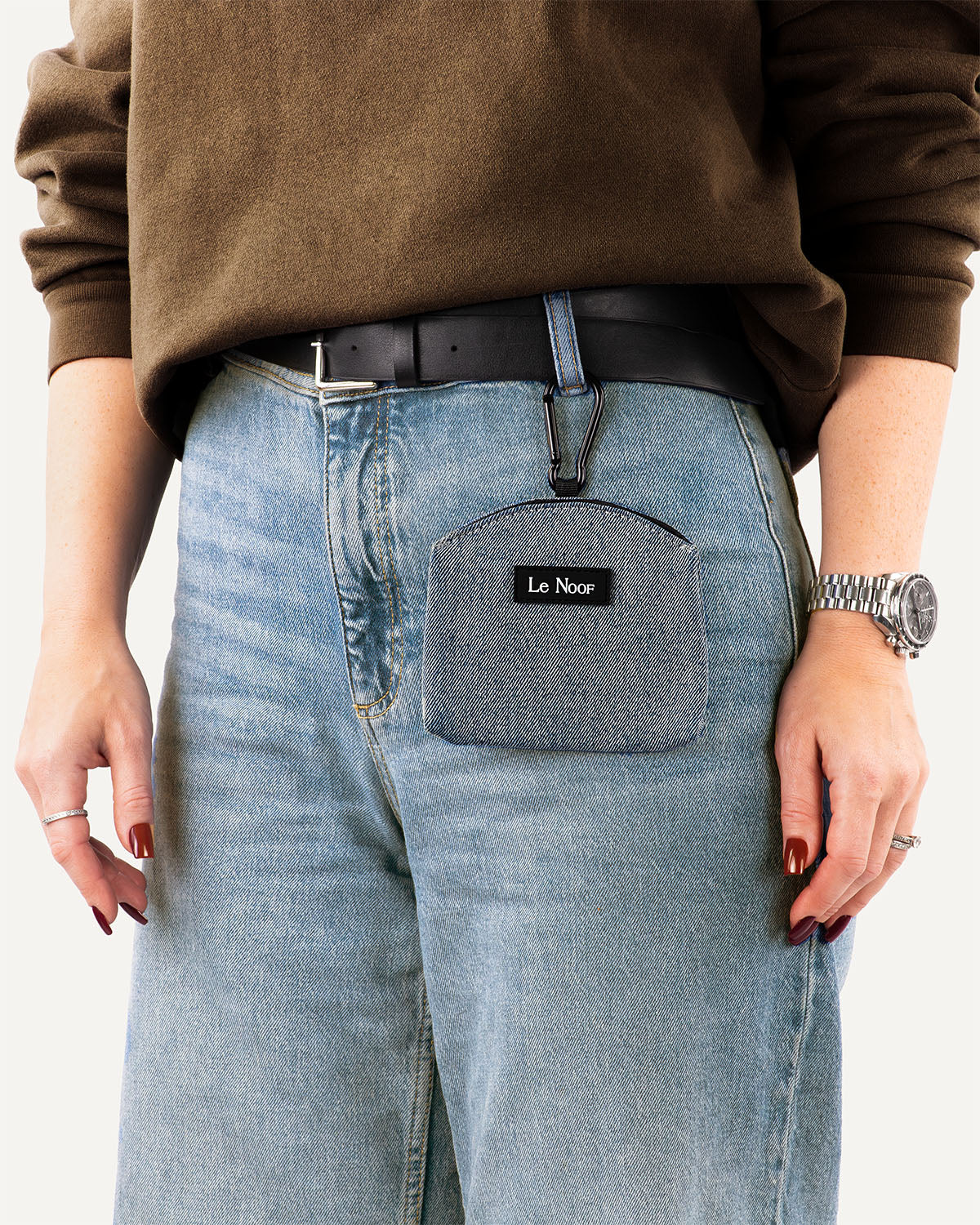 person wearing light blue denim jeans with matching dog treat pouch made by Le Noof