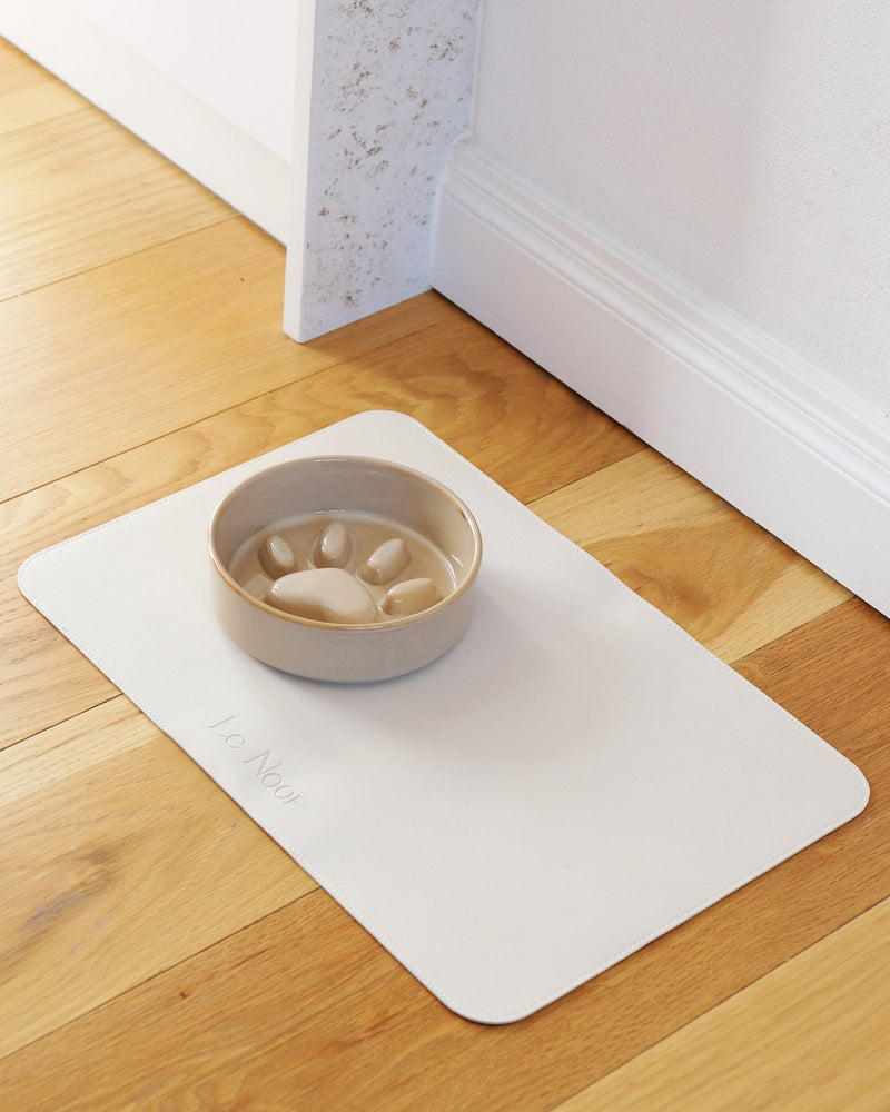 Waterproof dog bowl mat by Le Noof in beige color