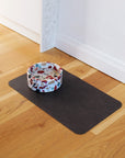 Black Pu leather dog bowl mat on kitchen floor with marble bowl