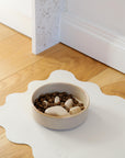 Brown ceramic dog bowl on PU leather dog bowl mat Le Noof