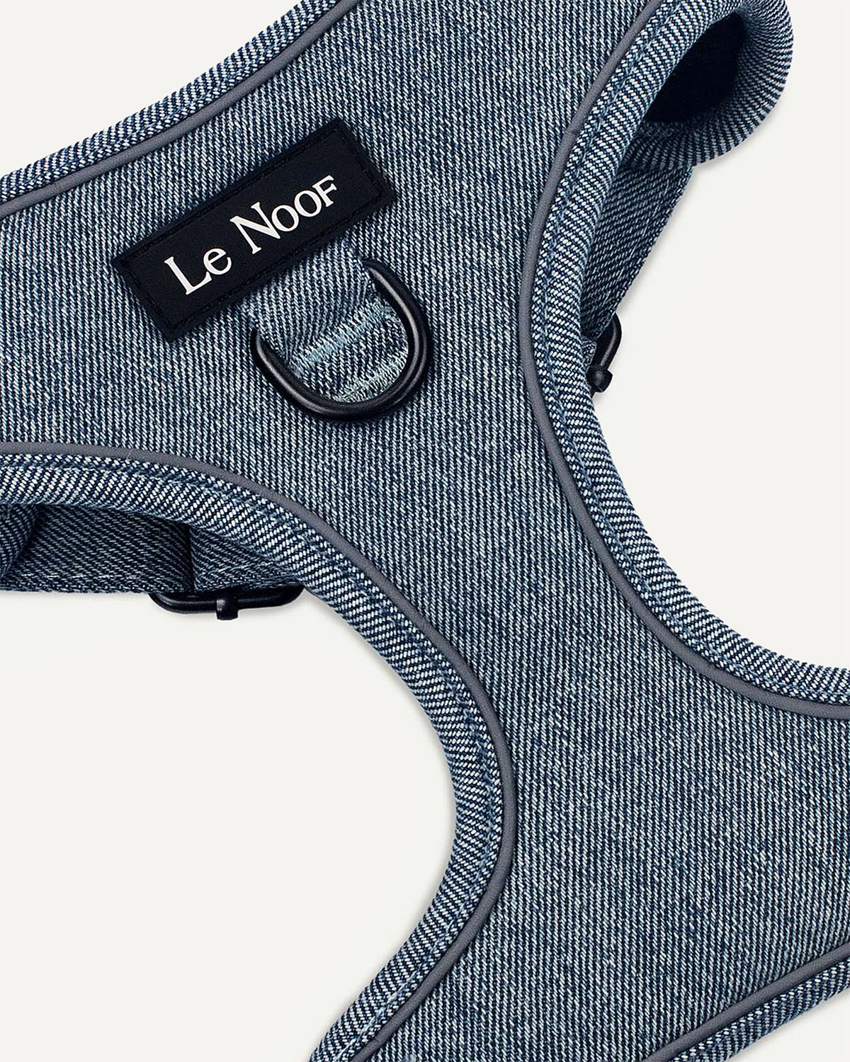 Light blue denim dog harness with Le Noof logo super closeup