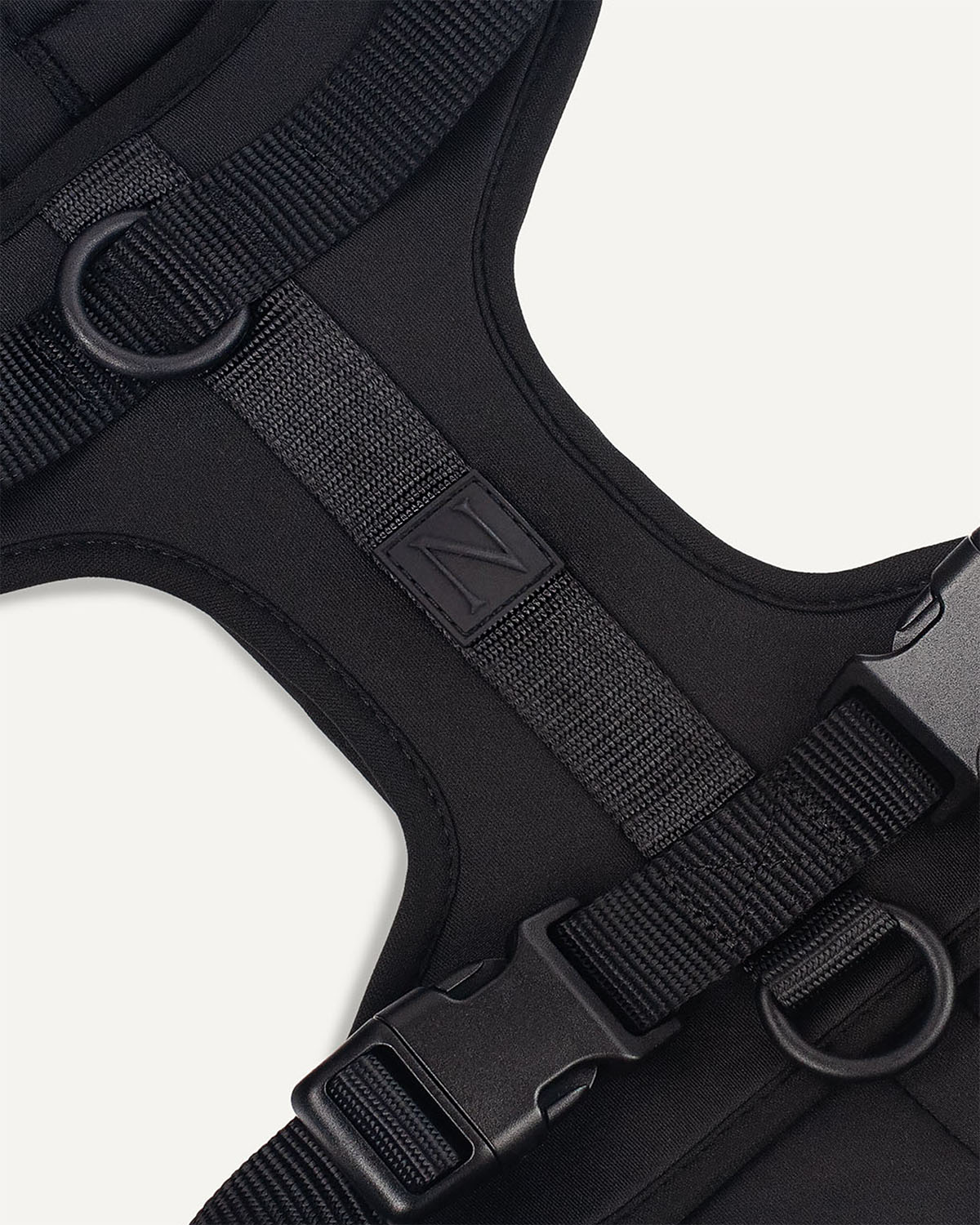 Black dog harness with Le Noof logo super closeup
