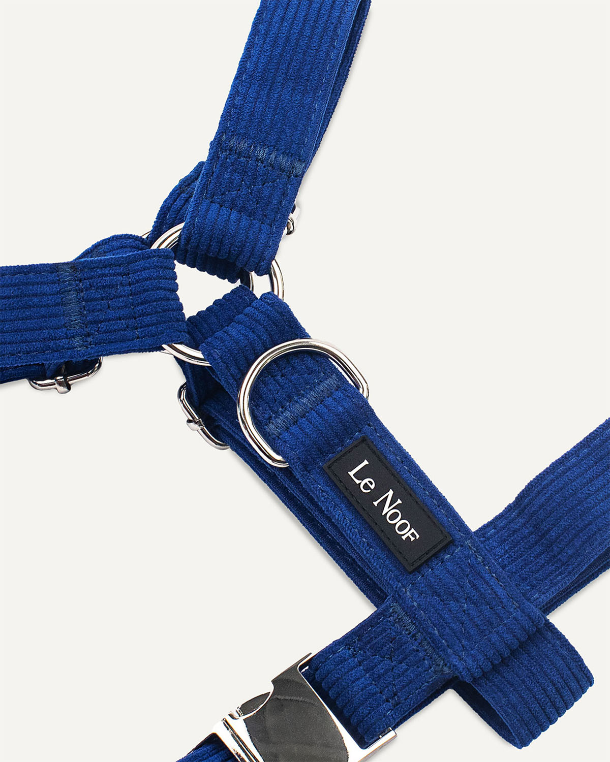 Blue corduroy dog harness with Le Noof logo super closeup