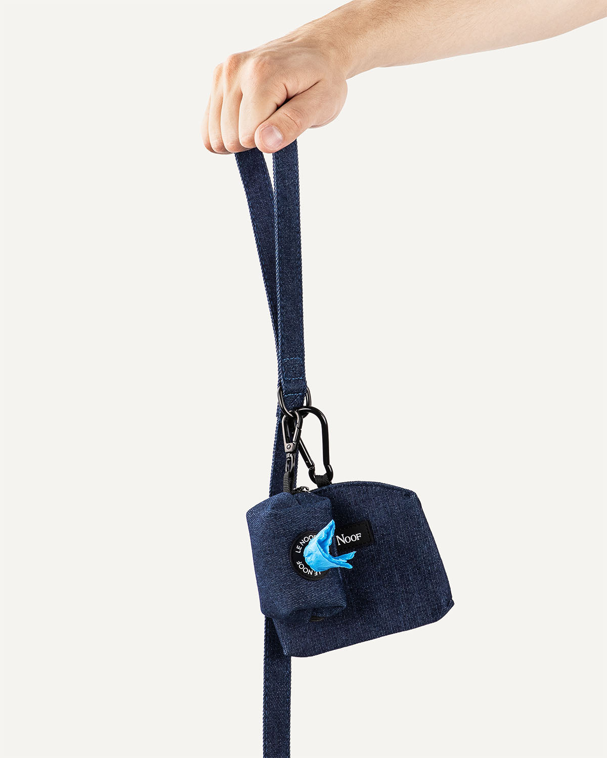 Dark blue denim dog leash with poop bag holder and treat pouch clipped to it with Le Noof logo