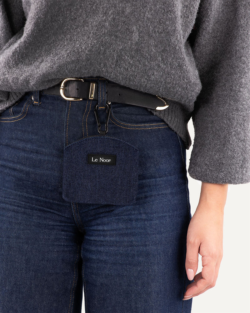 Woman wearing Le Noof's dark blue denim dog treat pouch