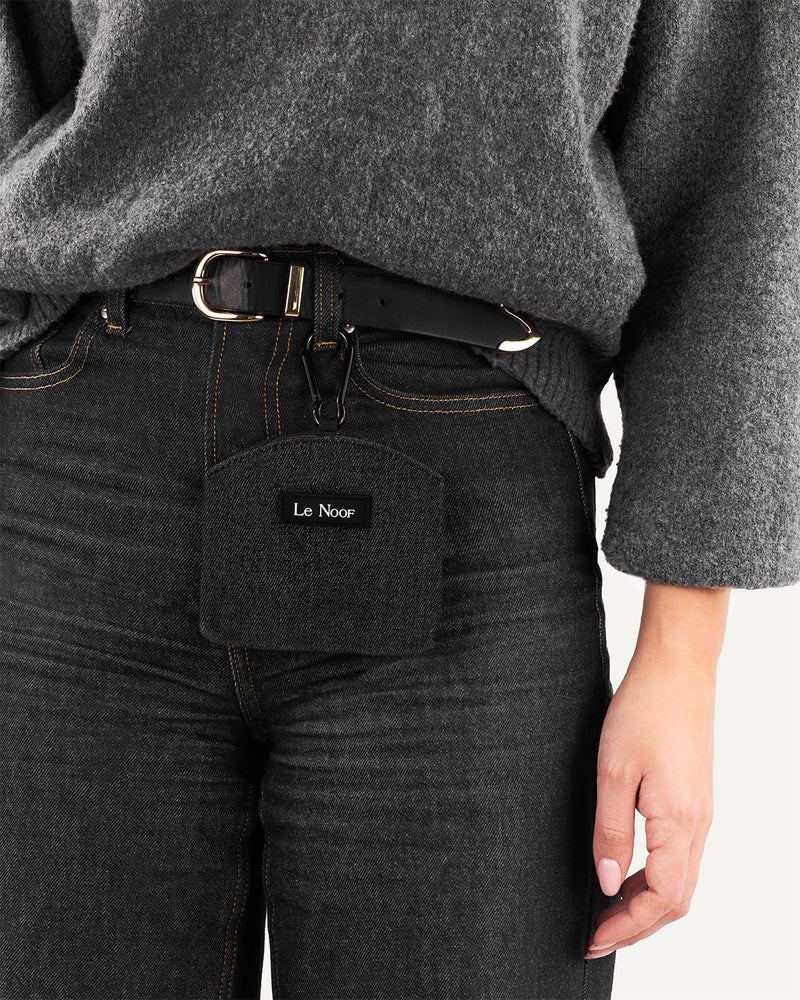 Dark washed denim dog treat bag clipped on persons belt loop made by Le Noof