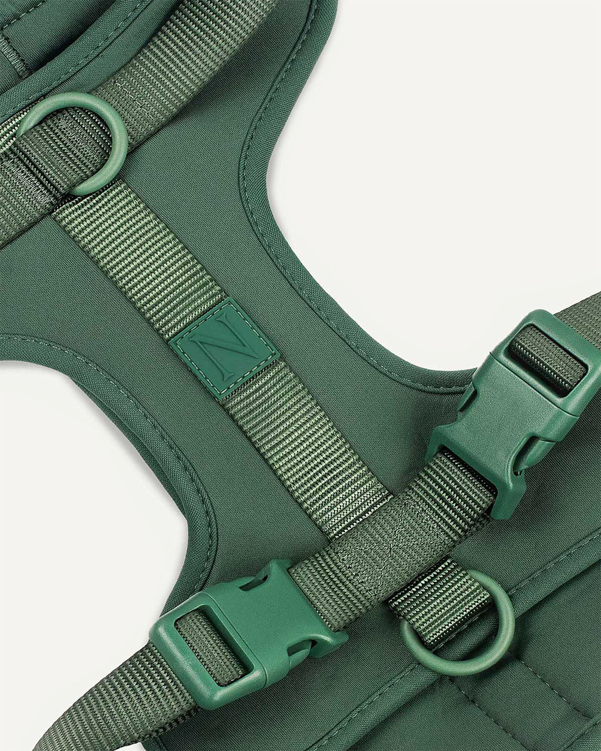 Green dog harness with Le Noof logo super closeup