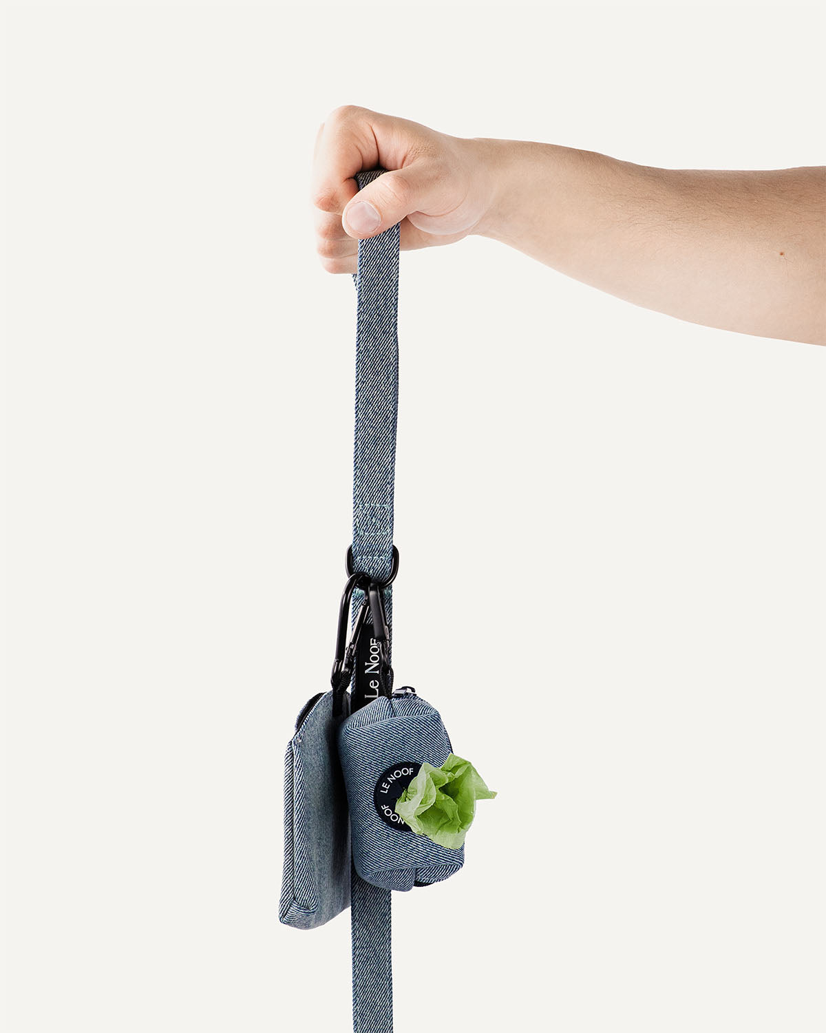 Light blue denim dog leash with poop bag holder and treat pouch clipped to it