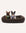 Two dogs sitting on a brown pet bed with a white background